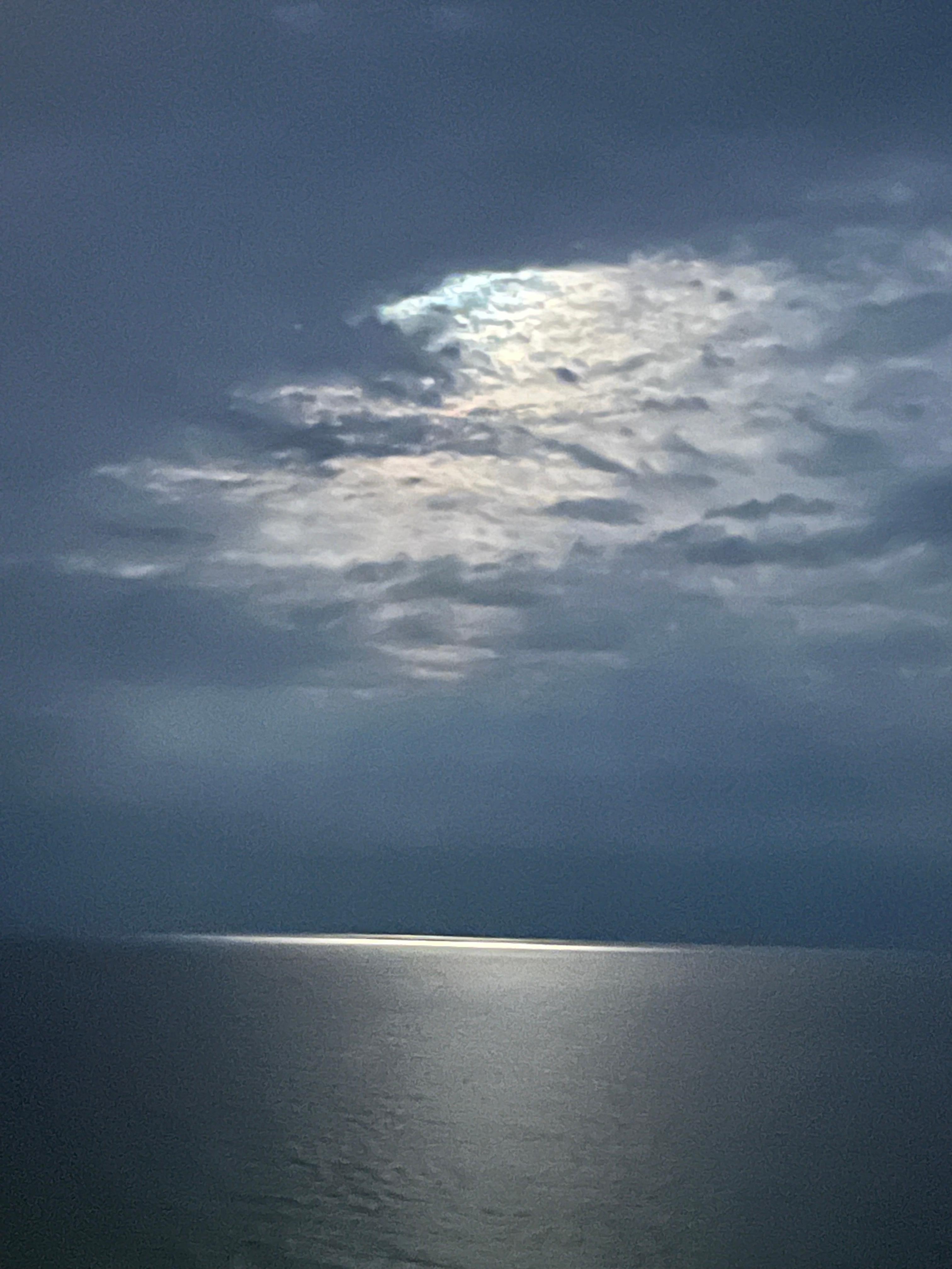 Moon peeking thru clouds onto the Gulf