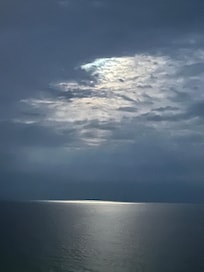 Moon peeking thru clouds onto the Gulf