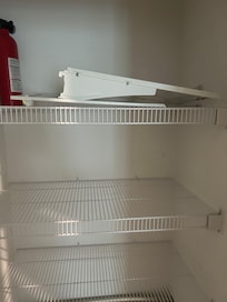 Parts of the shelf from refrigerator in closet in kitchen