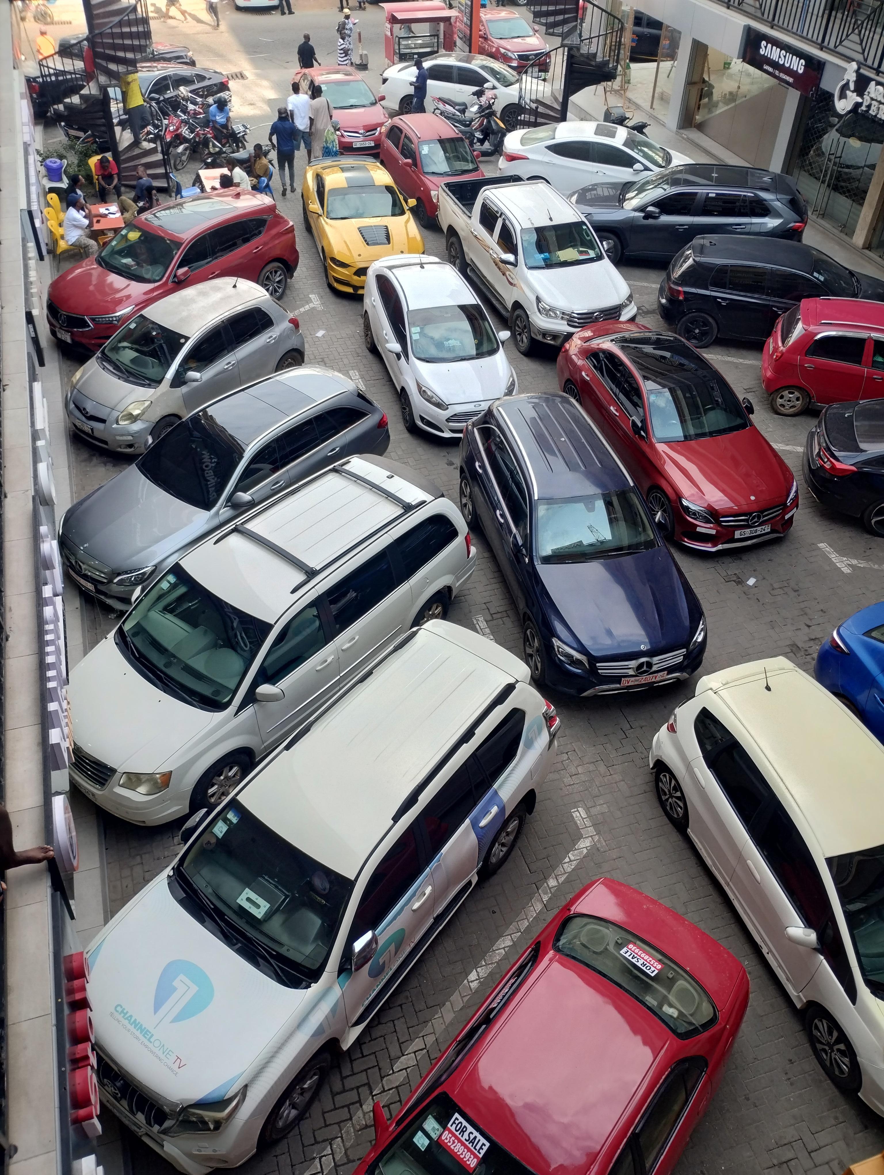 My car is the one with a roof rack. 3rd Car counting from the red car with the "for sale sign" I couldn't move my car. I had to take Bolt to go out.
