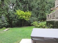 Looking past the hot tub toward a nook with some nice landscaping (and a waterfall), and you can see our deck rail to the right.
