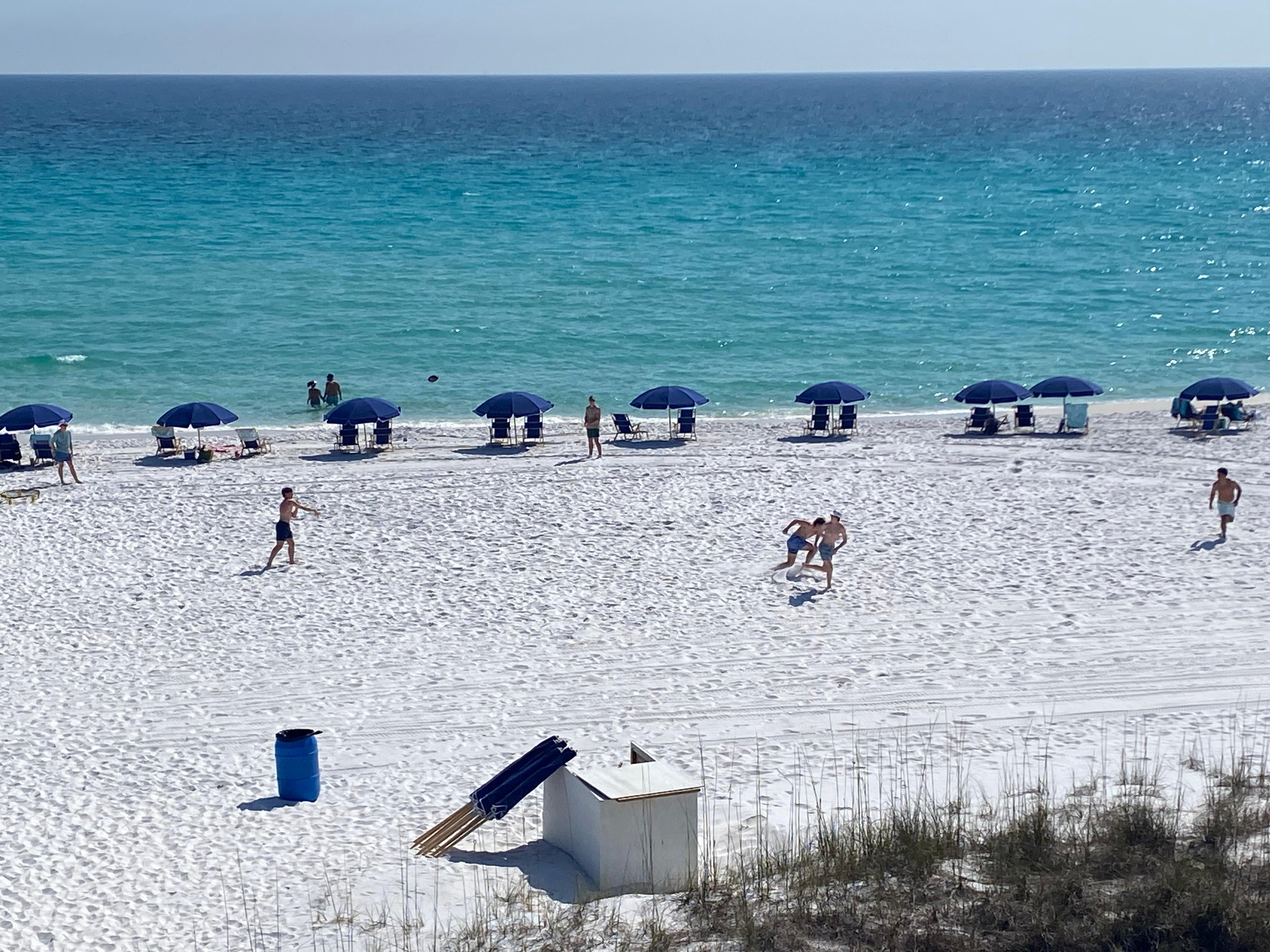 View from the balcony in the morning with beach chairs and umbrellas out. 
