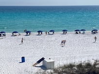 View from the balcony in the morning with beach chairs and umbrellas out.
