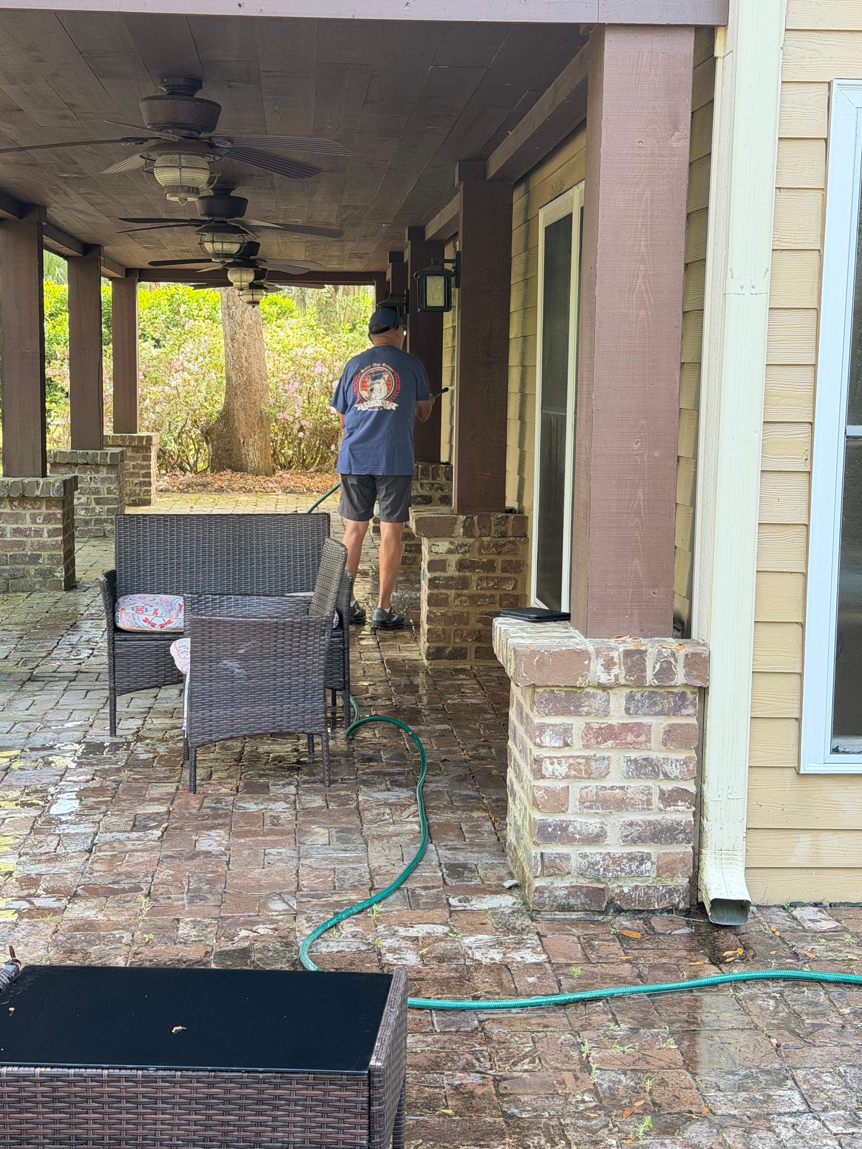 My husband cleaning the back windows and doors