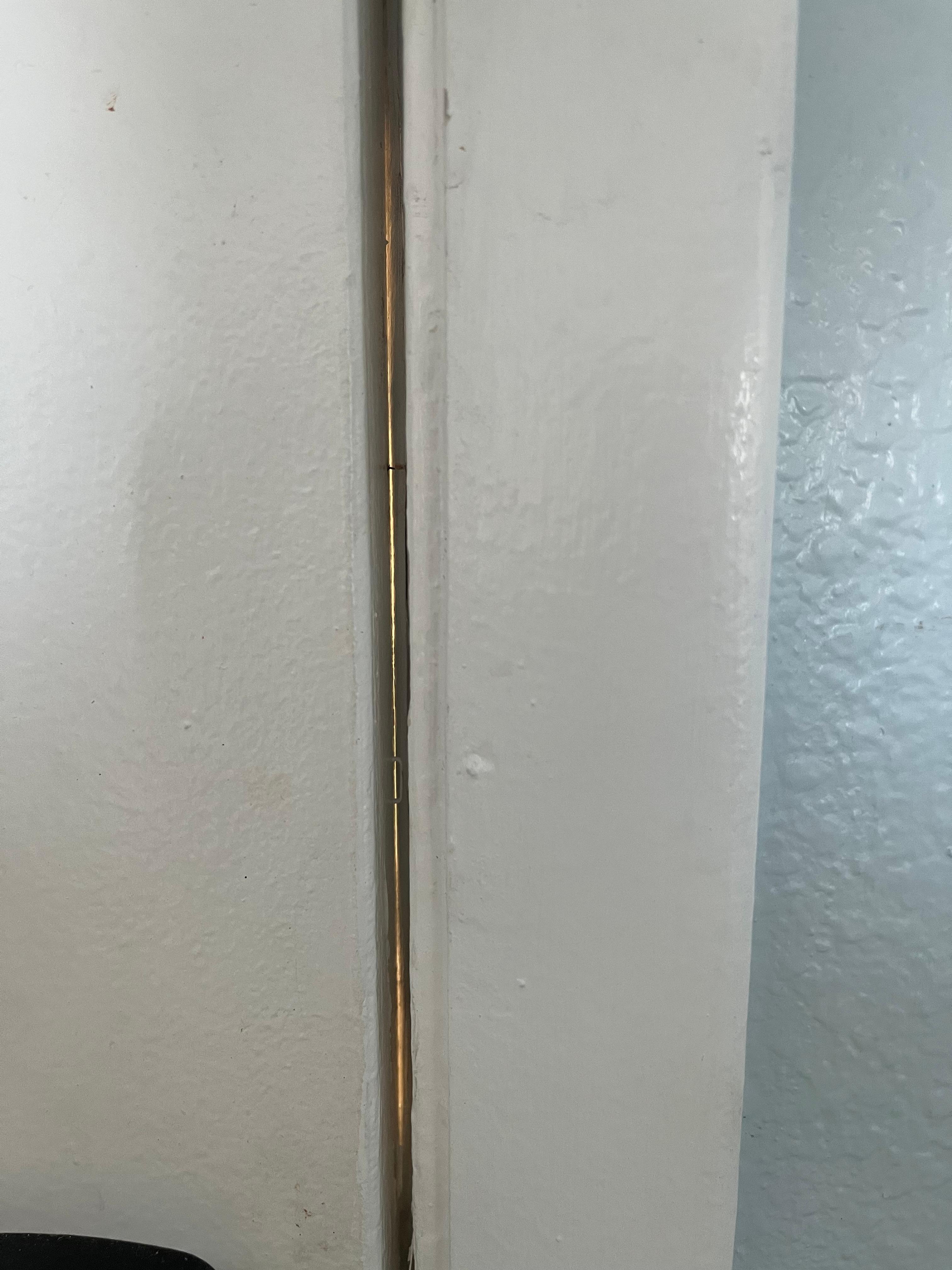 Gap in door large enough that I could see people moving around outside the door 