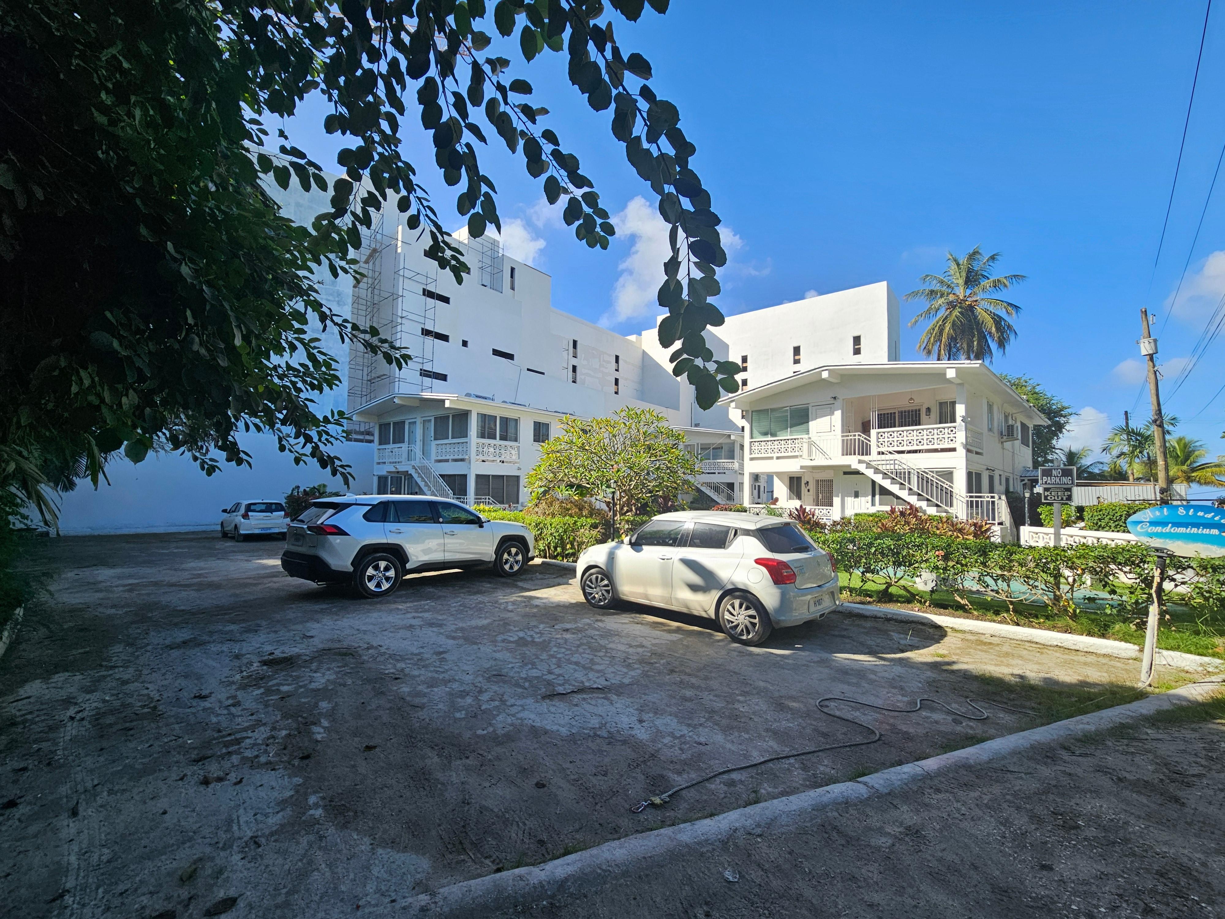 The apartment is located on the ground floor of the building on the left. 