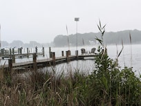 Early morning mist from the back yard looking at the dock and river