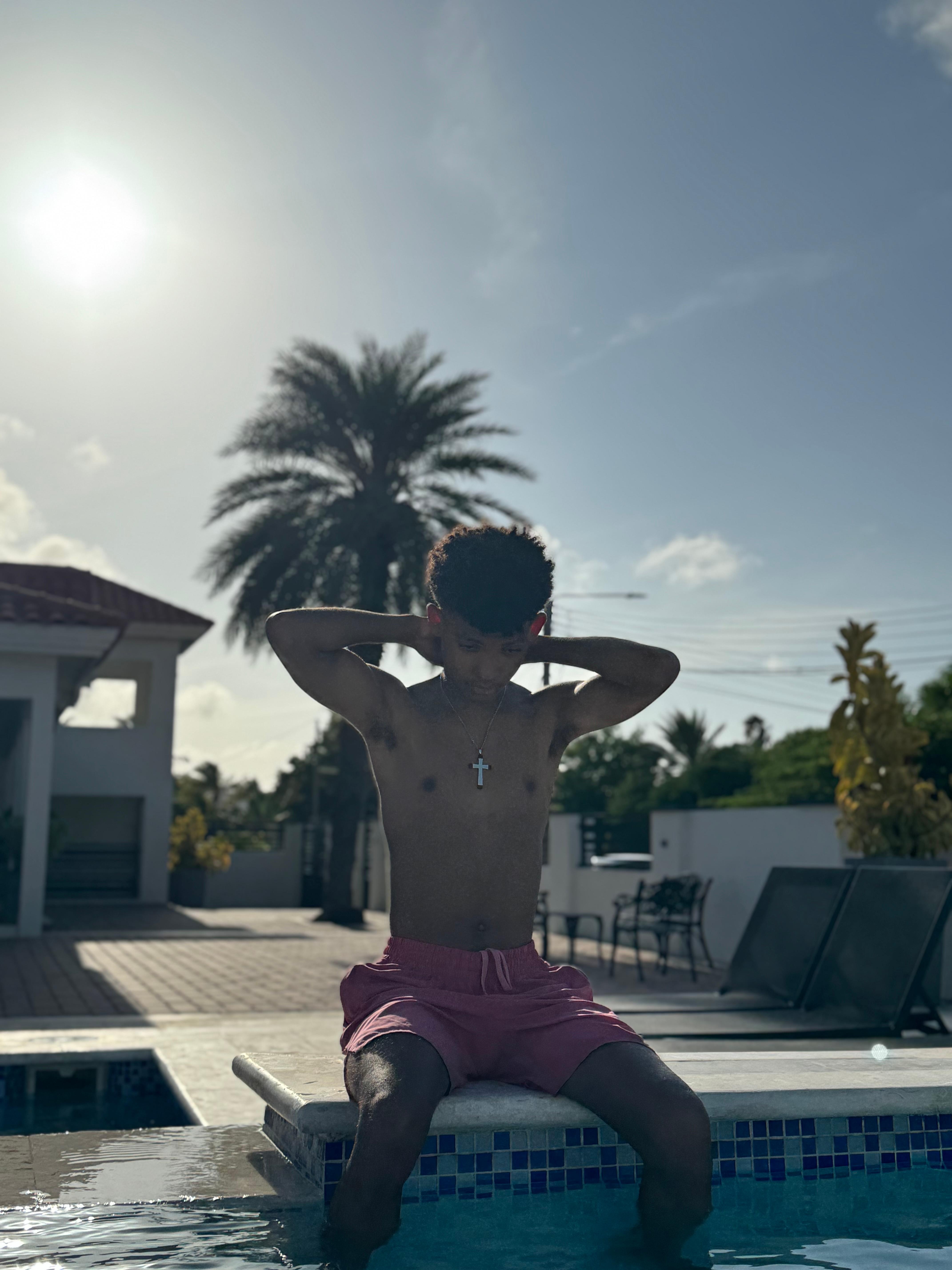 son relaxing poolside