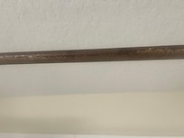 Shower rod in bathroom near room with 3 double beds