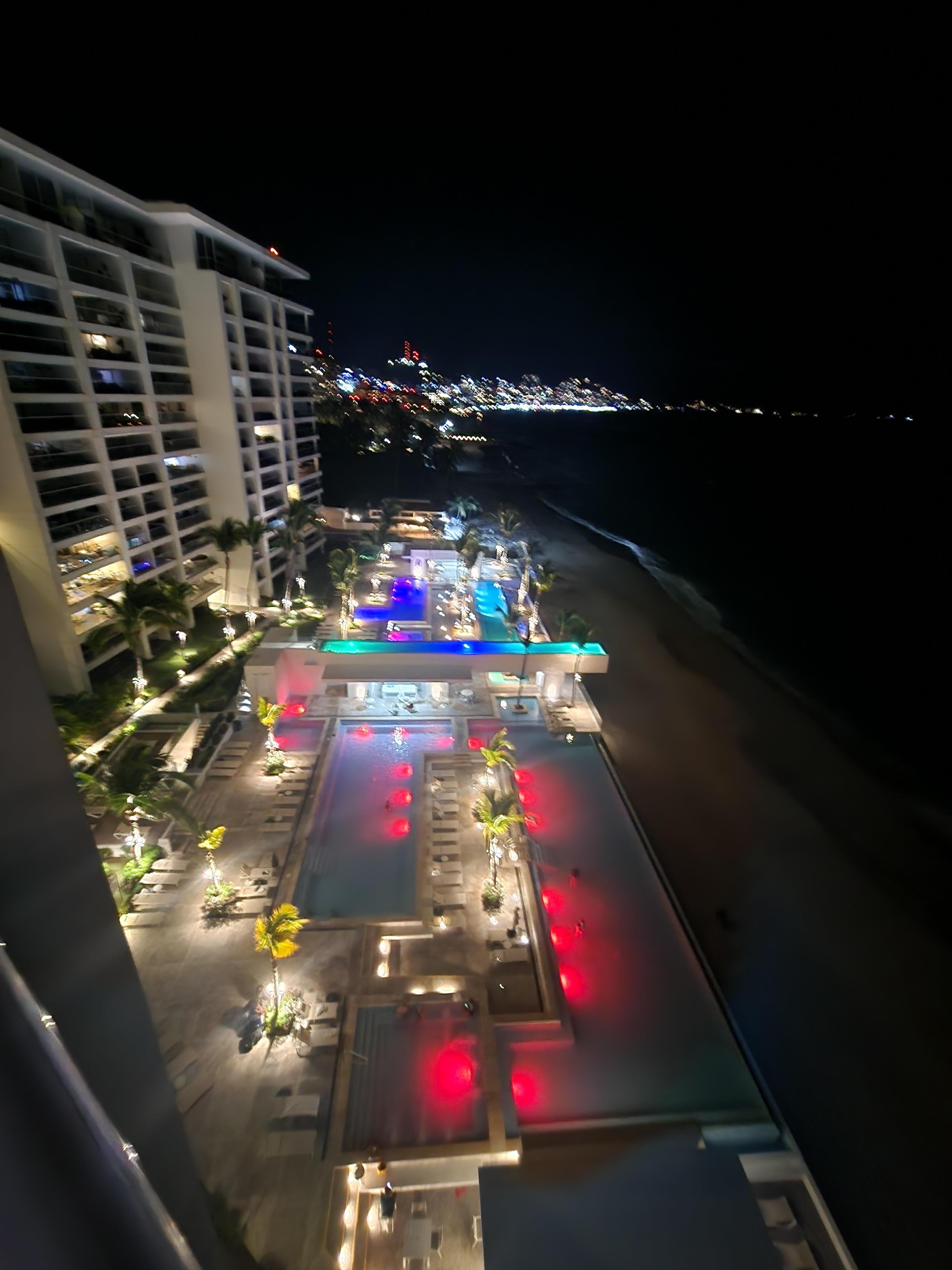 View over the pools with changing lights at night