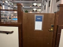 Indoor pool and atrium viewed from room doorway.