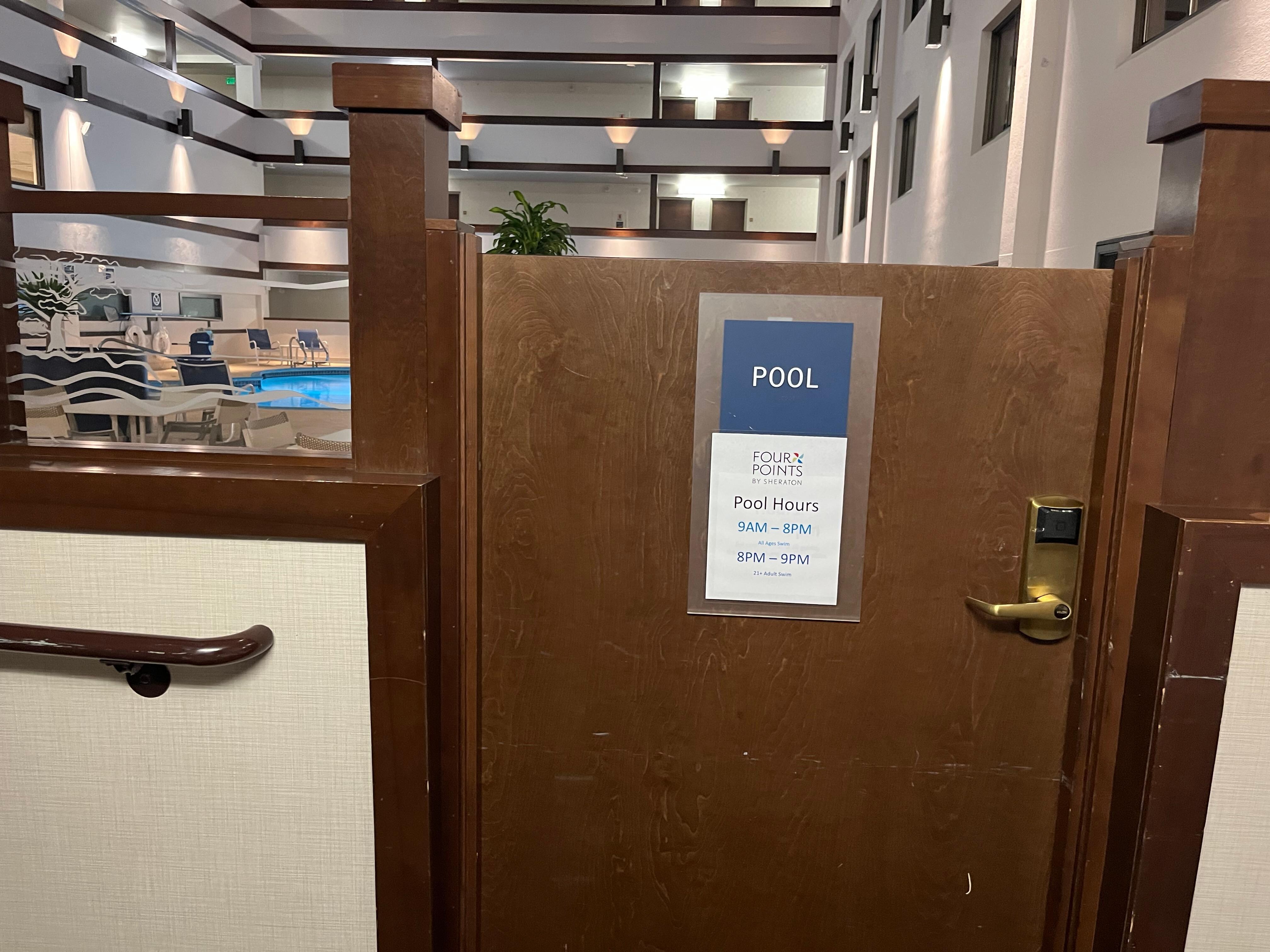 Indoor pool and atrium viewed from room doorway. 