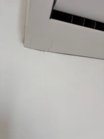 Leaky AC pouring water down the wall