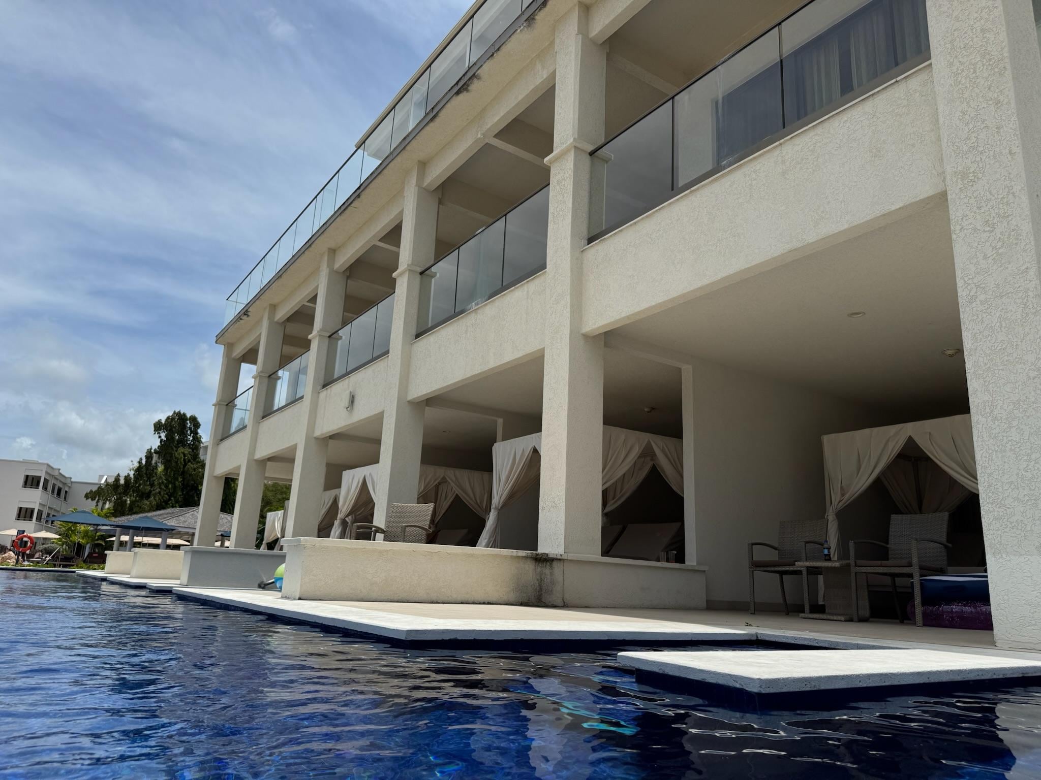 View of shared swim up pool area rooms/building