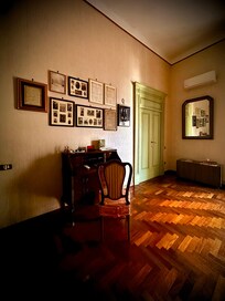 The apartment is furnished with a charming collection of antiques and mementos.
