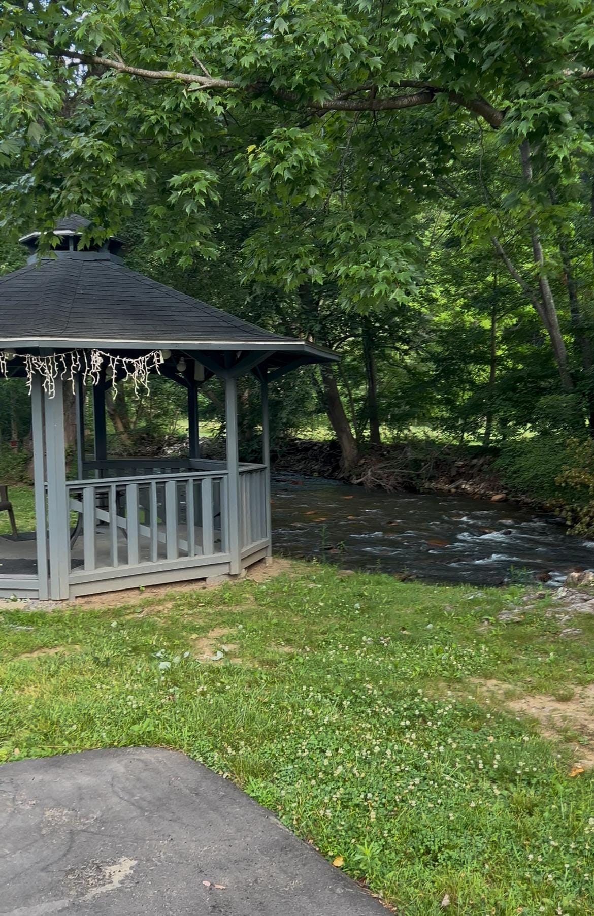 Swings, gazebo and fire pit for relaxing along the water.