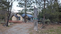 The house is set in a quiet forested neighborhood.