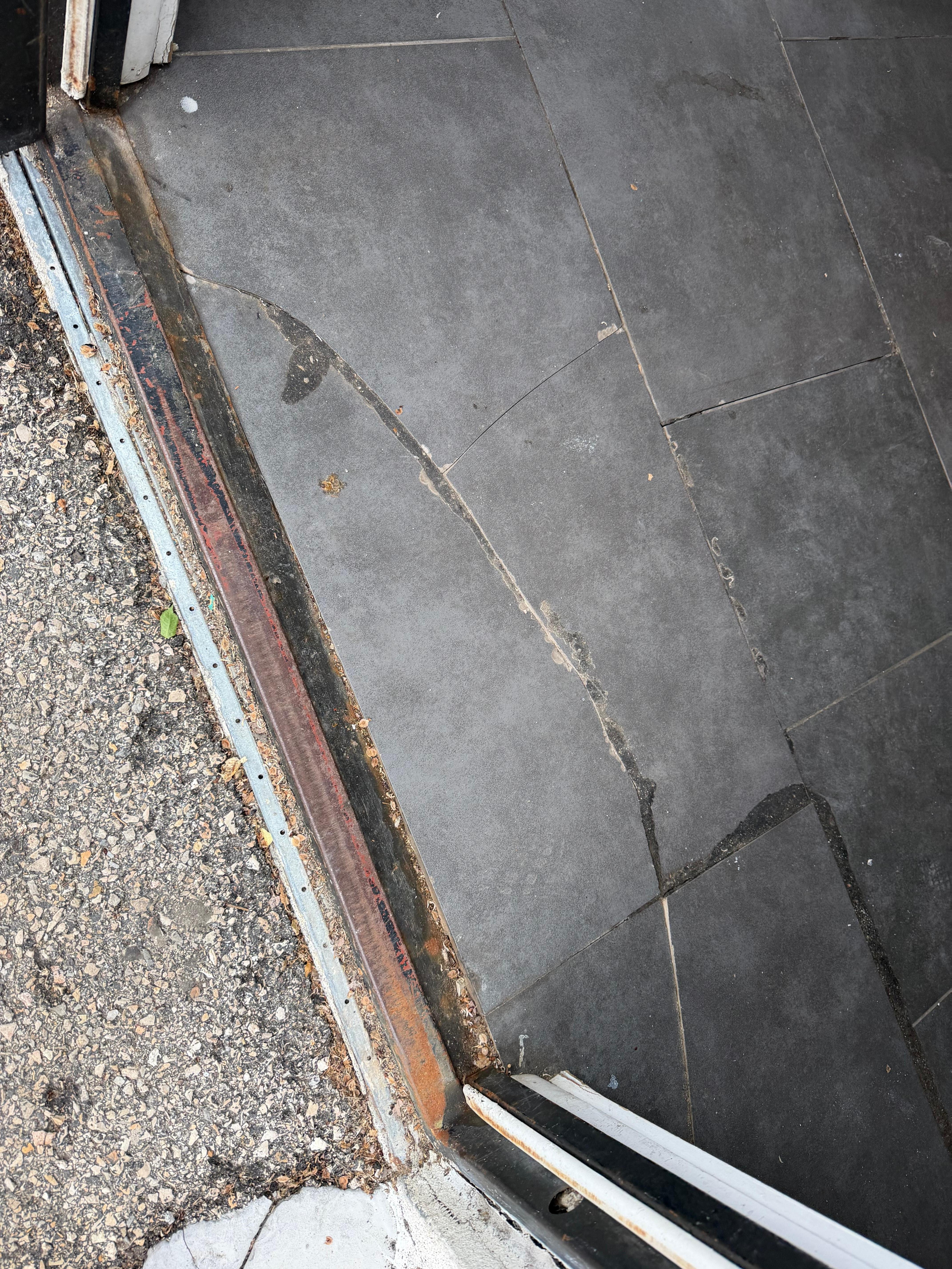 Tripping hazard at entrance of complex from parking.