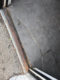 Tripping hazard at entrance of complex from parking.