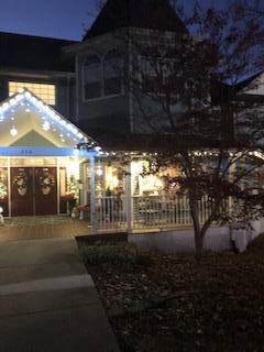 The entrance has an inviting wrap around porch with seats to watch the stars