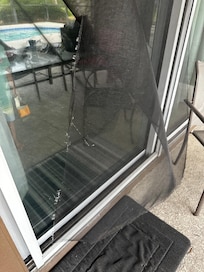 Sliding screen door unusable. Screens around pool were also pushed out