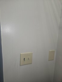 Dirty walls and paint/stain splatter on most walls and floors.