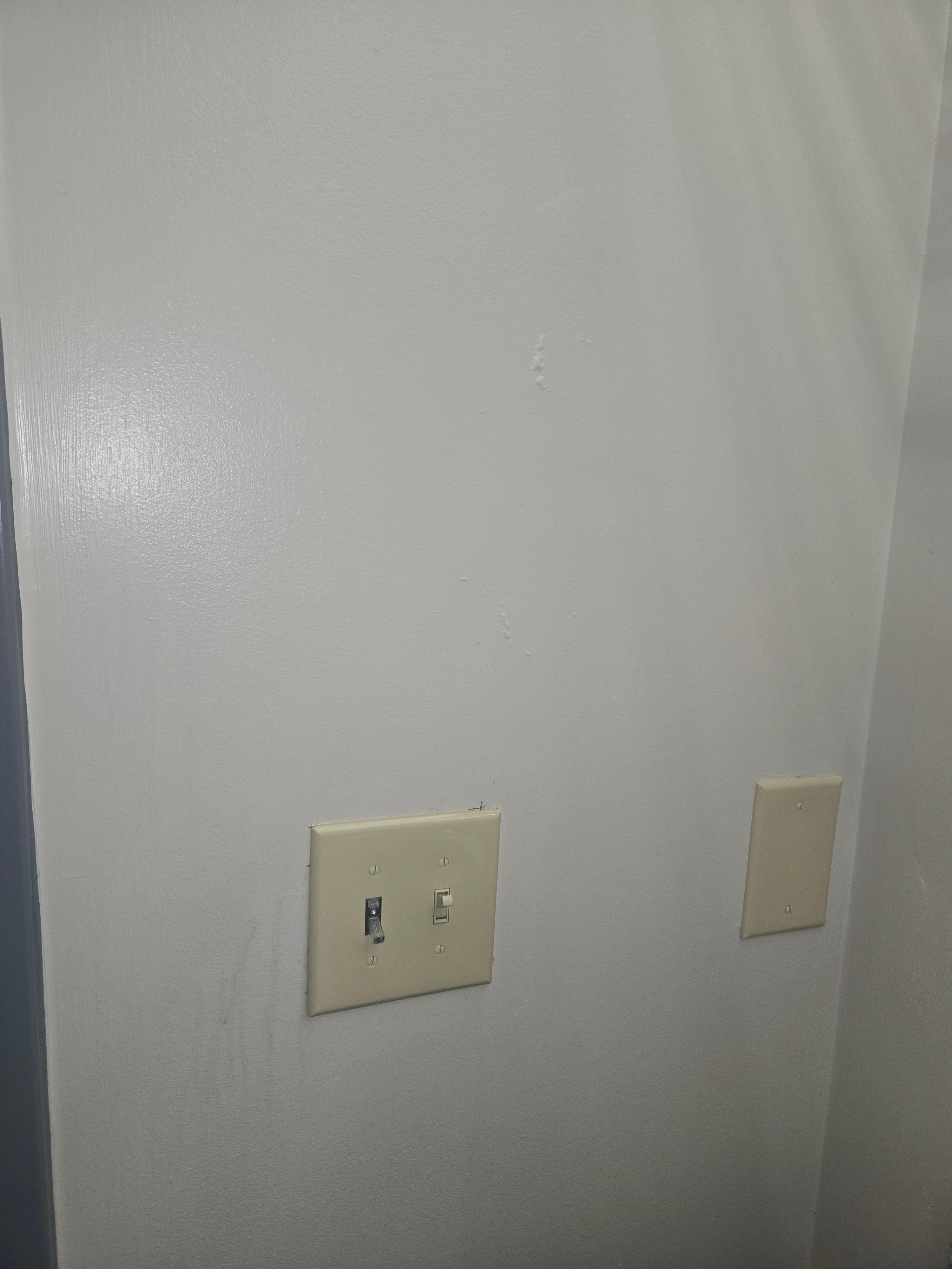 Dirty walls and paint/stain splatter on most walls and floors.