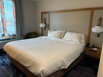 One king-sized bed with individual lamps on each side.