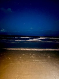 Looking at stars and watching the waves come in .