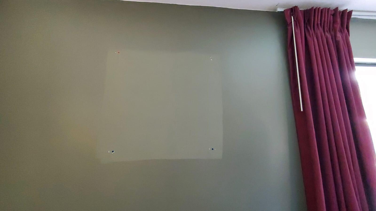 Room needing painting from a removed picture
