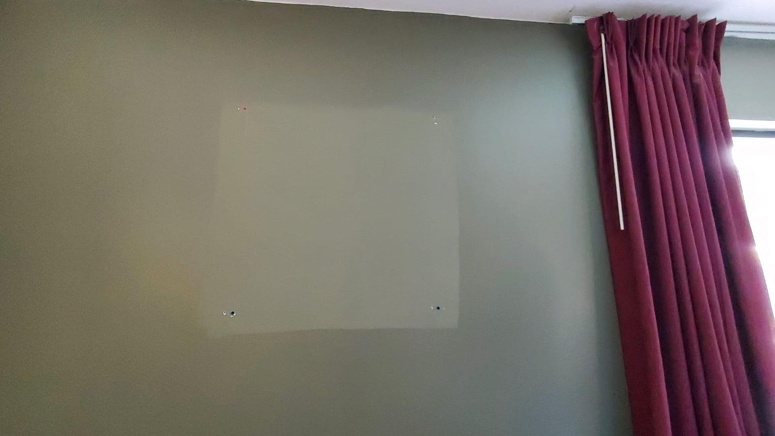 Room needing painting from a removed picture