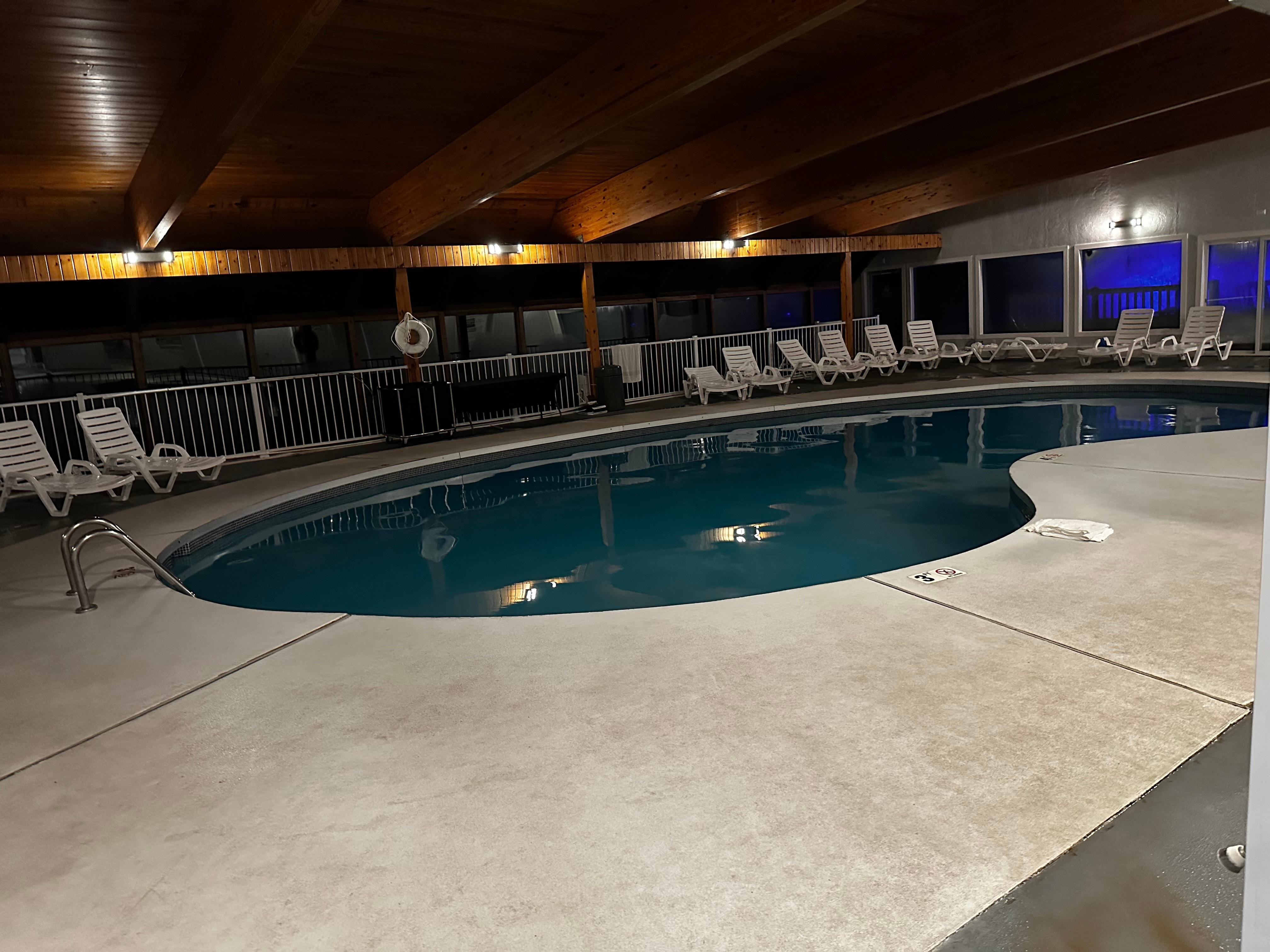 Old school bean shaped pool with hot tub. Beautiful views of the lake from the pool area. 