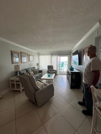 A spacious living and dining area beautifully decorated with colors of the sea