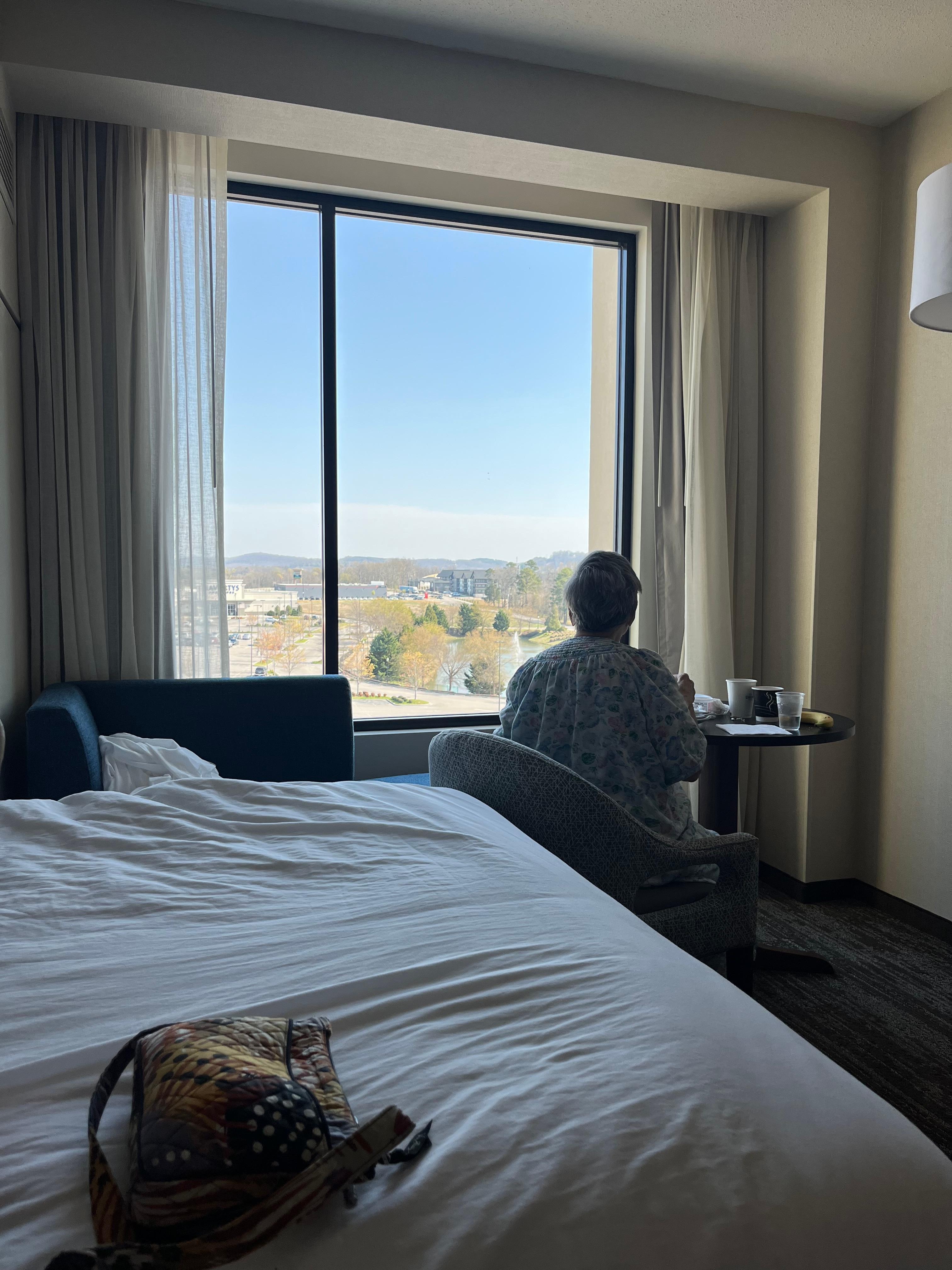 My mom enjoying her coffee and breakfast while she looks out the window. 