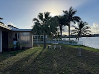 View of the backyard and lake. Entrance to the suite on the left.