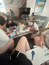 The teens doing beach inspired artwork.