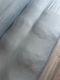 Couch that was not only exceptionally lumpy but also dirty and stained.