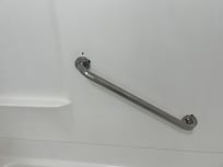 Holes in the shower wall because they tried to resecure the grab handle. It was still loose and would have easily broken off if a person were to have used it. It almost happened to me.