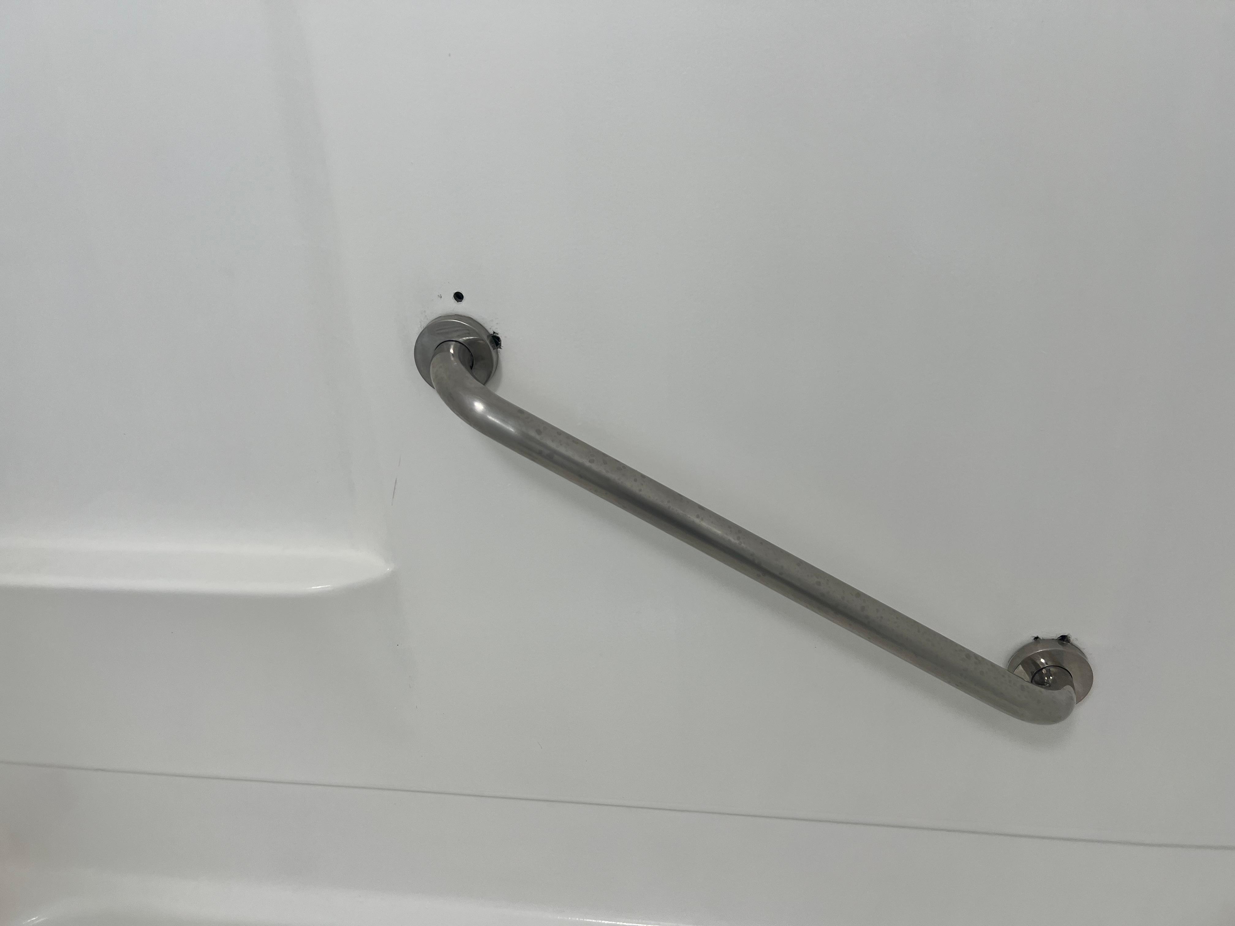 Holes in the shower wall because they tried to resecure the grab handle. It was still loose and would have easily broken off if a person were to have used it. It almost happened to me.