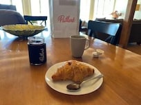 Croissant and jam at the kitchen table.