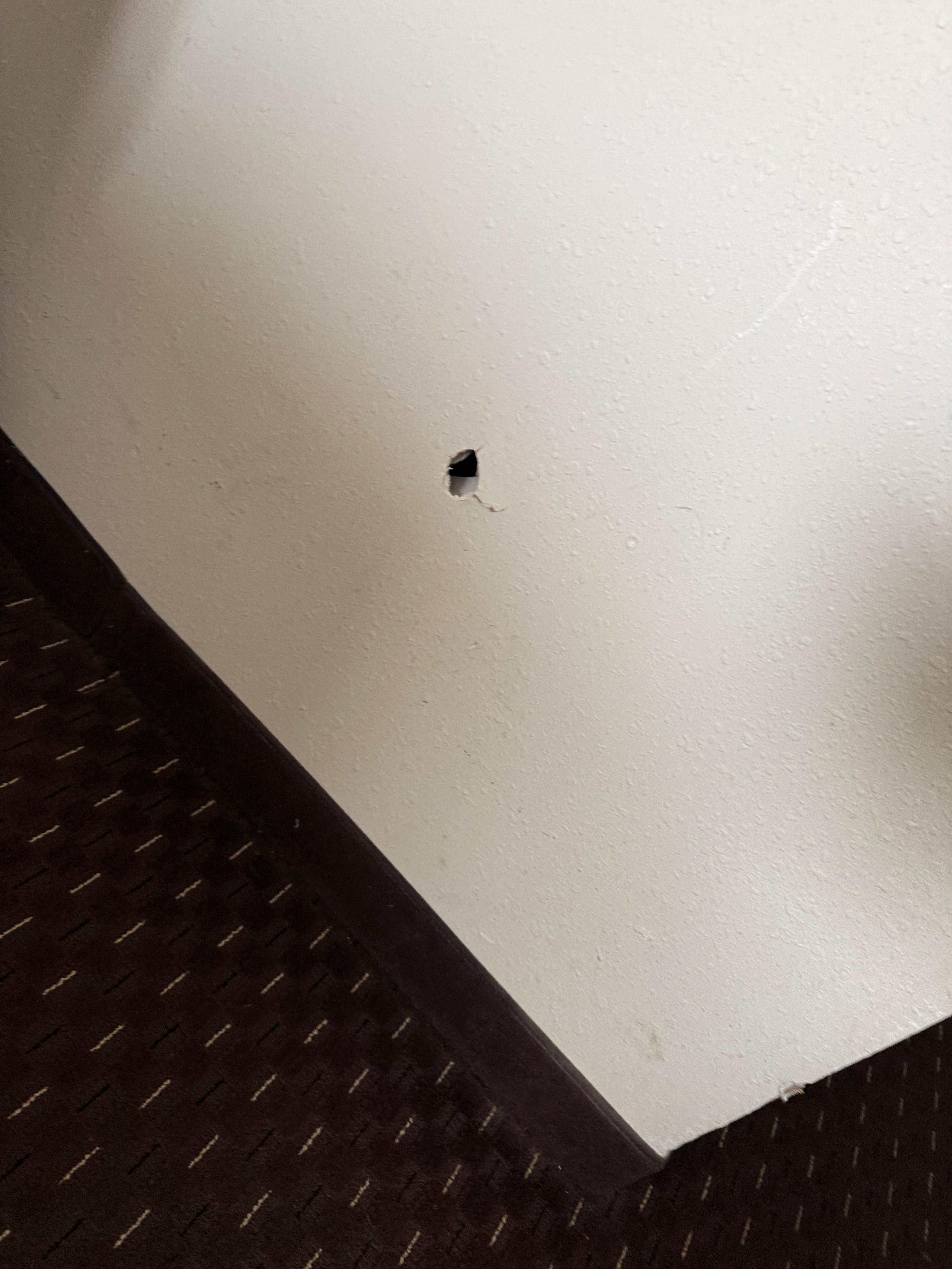 hole in wall by the bed