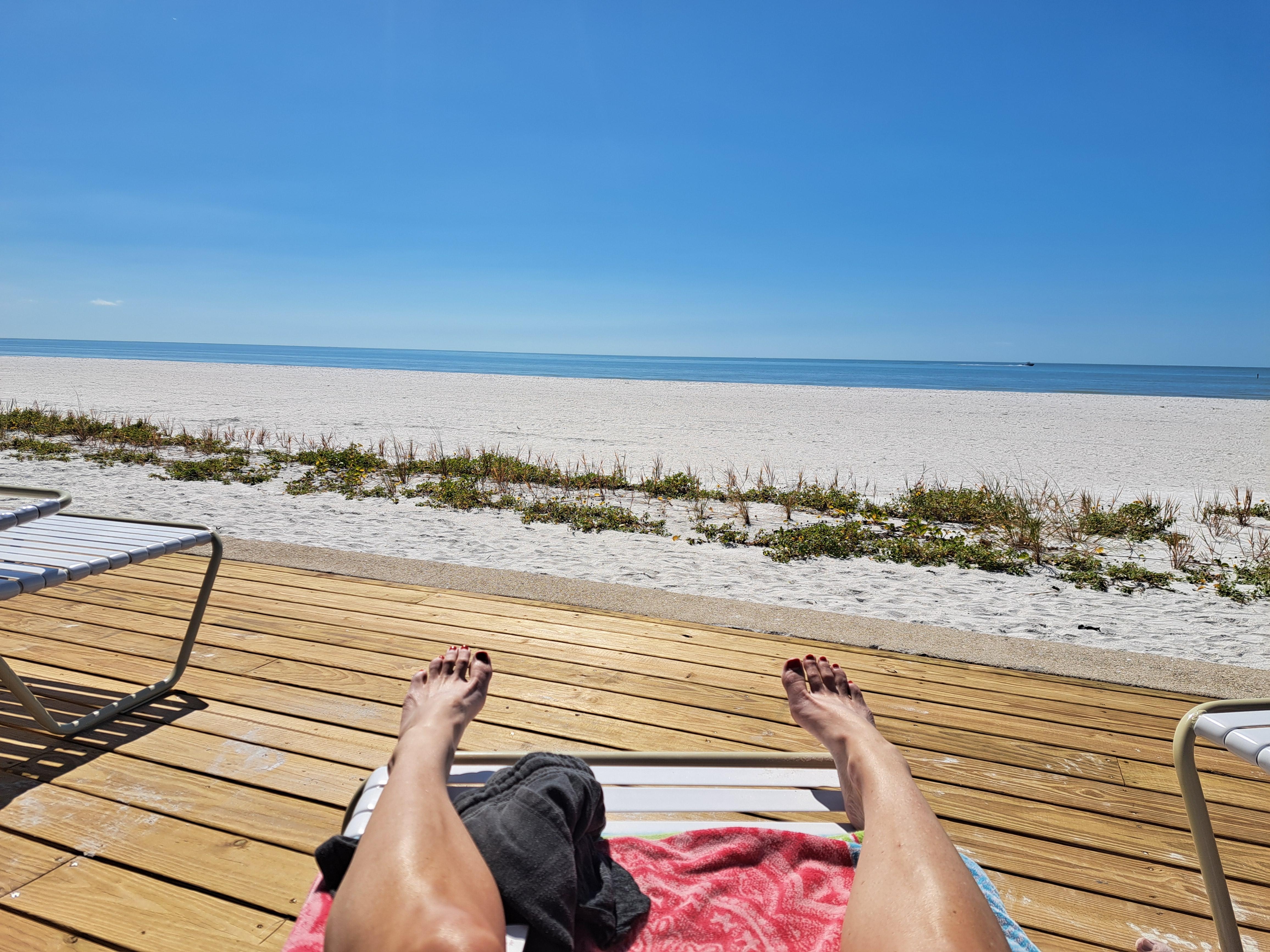 View of the beach from the unit deck chairs out back.