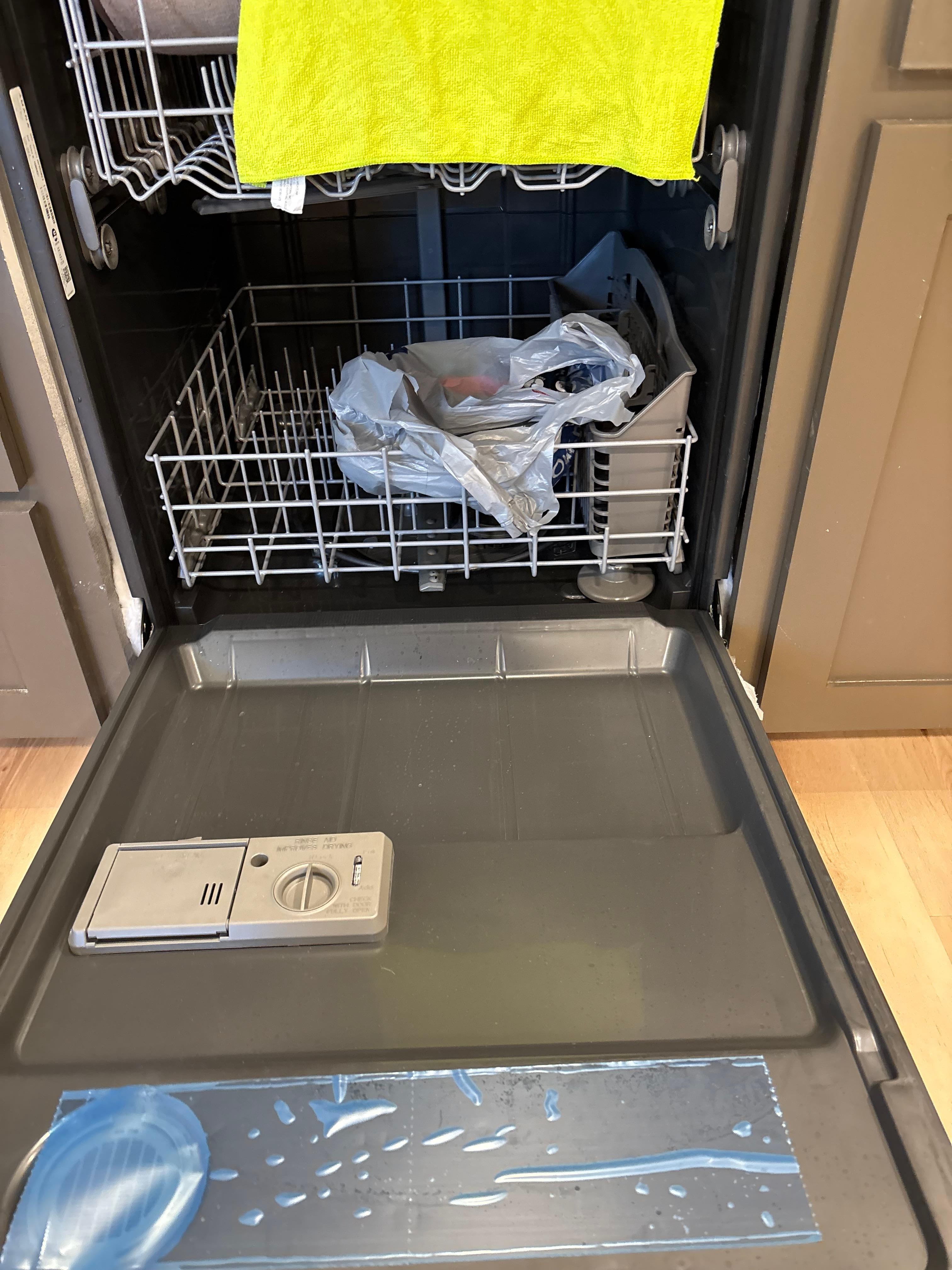 All dishwasher hookups in a bag inside dishwasher