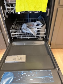 All dishwasher hookups in a bag inside dishwasher