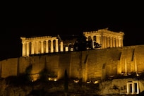 A nighttime photo of the Parthenon from the balcony.