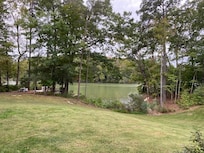 View of the property, dock, and water from the house