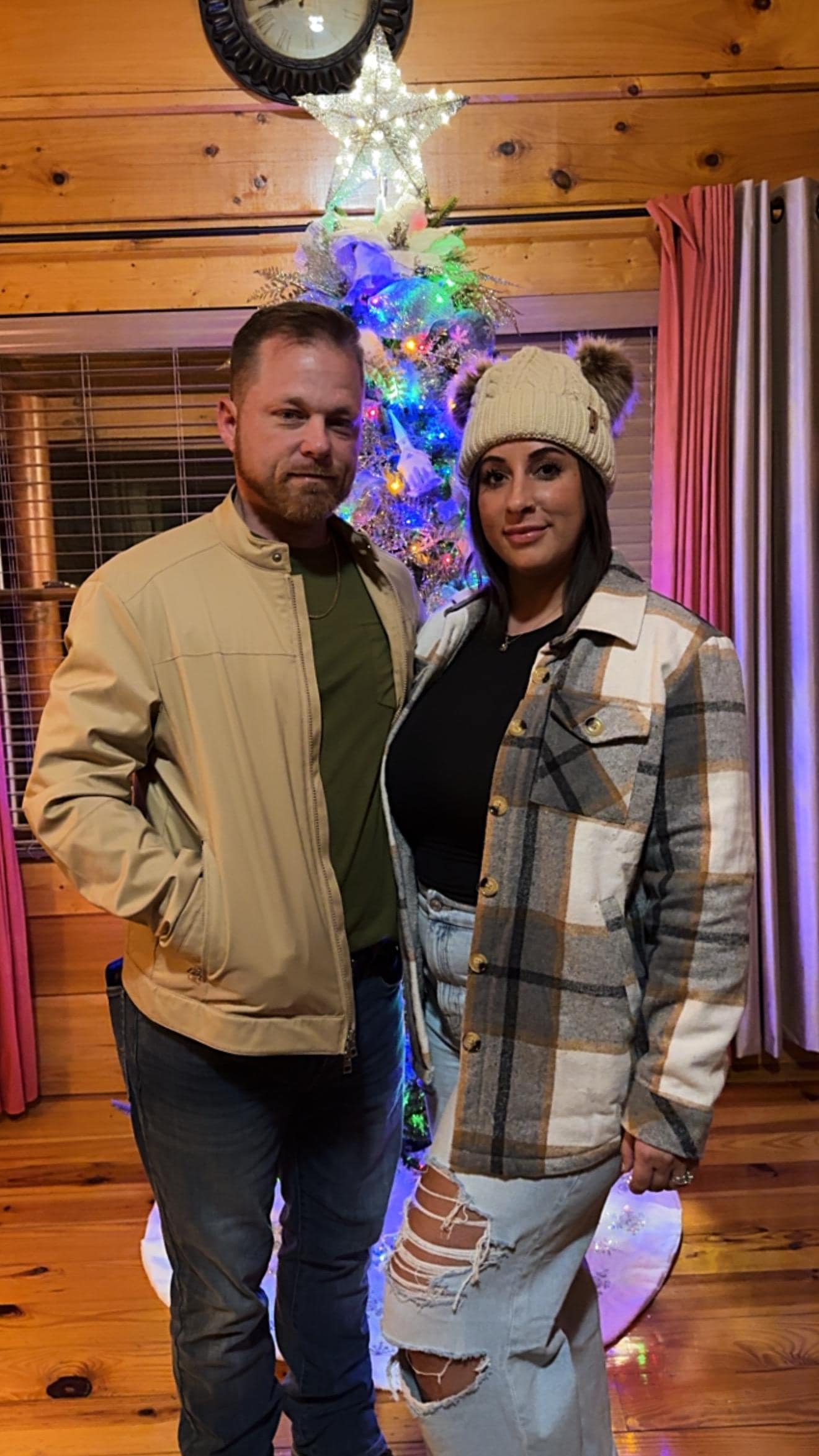 Me and wife by the Christmas tree in the cabin