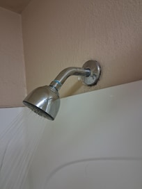 Shower head is in bad condition.