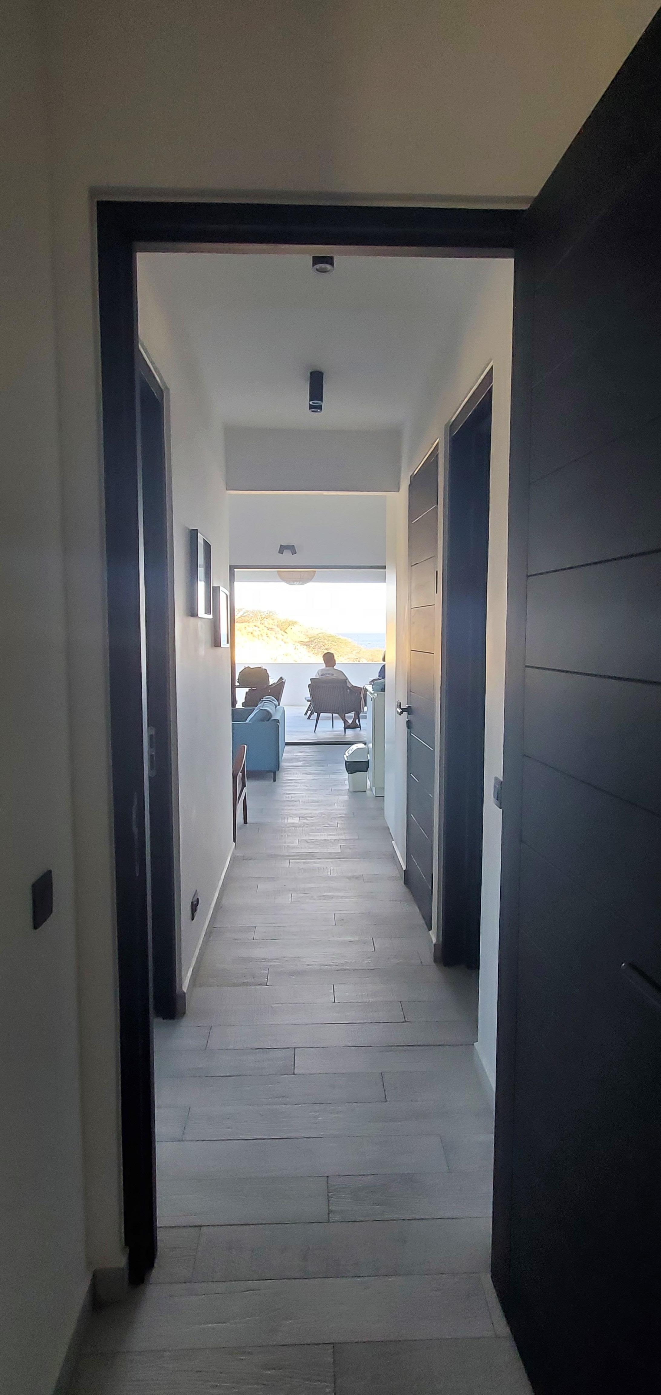 Looking from primary bedroom through the unit to the beautiful and enormous balcony area!