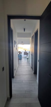 Looking from primary bedroom through the unit to the beautiful and enormous balcony area!